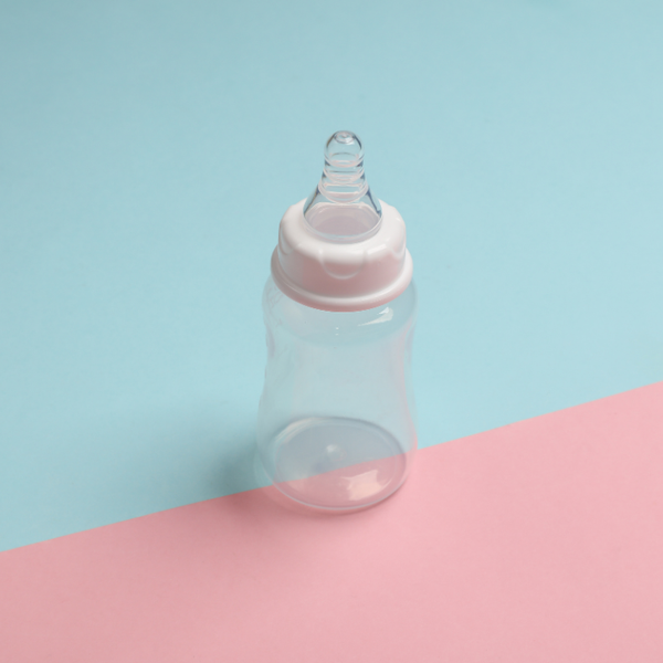 Baby bottle with blue and pink background